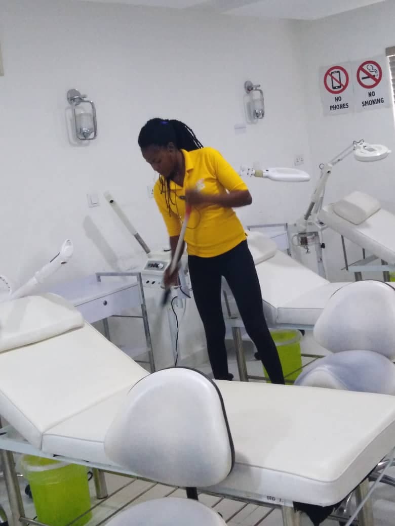 Professional cleaner sanitising a clinic in Abuja